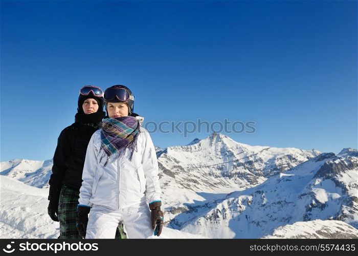 happy people group have fun on ski snow at winter season on mountain with blue sky and fresh air