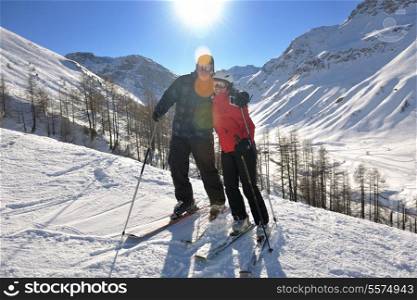 happy people group have fun on snow at winter season on mountain with blue sky and fresh air