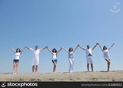 happy people group have fun run and jump on beach beautiful sand beach