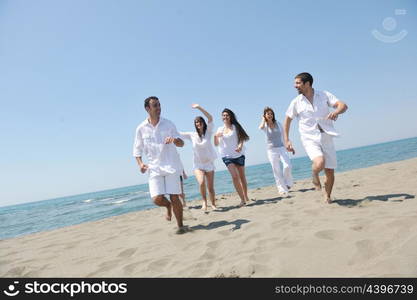 happy people group have fun run and jump on beach beautiful sand beach