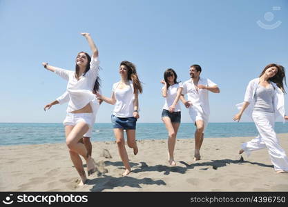 happy people group have fun run and jump on beach beautiful sand beach