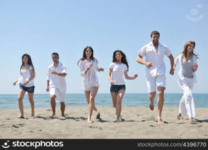 happy people group have fun run and jump on beach beautiful sand beach