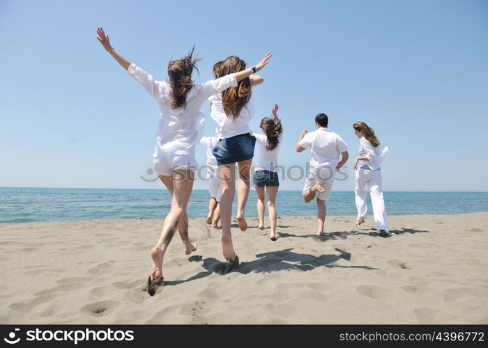 happy people group have fun run and jump on beach beautiful sand beach