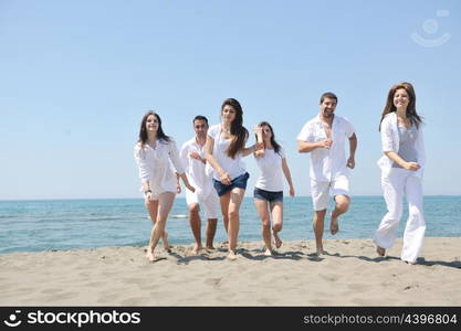 happy people group have fun run and jump on beach beautiful sand beach