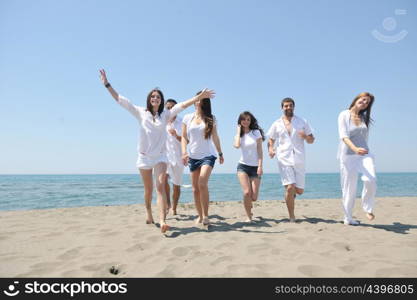 happy people group have fun run and jump on beach beautiful sand beach