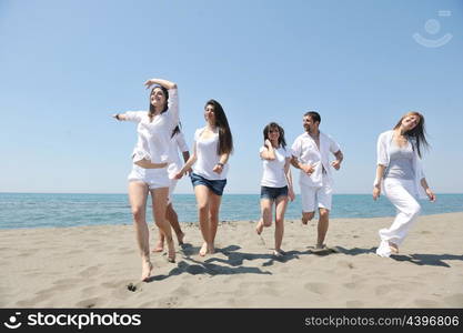 happy people group have fun run and jump on beach beautiful sand beach