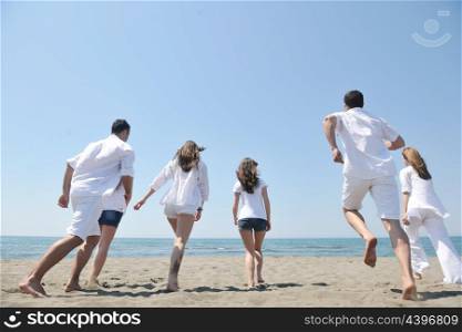 happy people group have fun run and jump on beach beautiful sand beach