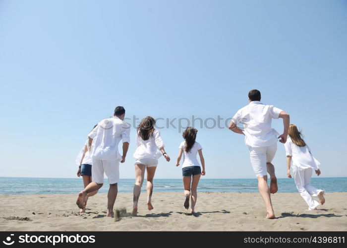 happy people group have fun run and jump on beach beautiful sand beach