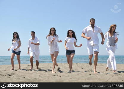 happy people group have fun run and jump on beach beautiful sand beach