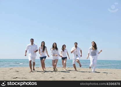 happy people group have fun run and jump on beach beautiful sand beach