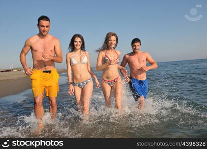 happy people group have fun run and jump on beach beautiful sand beach