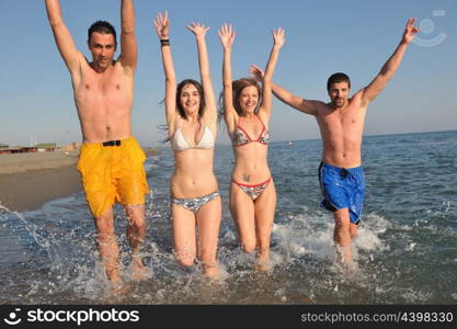 happy people group have fun run and jump on beach beautiful sand beach