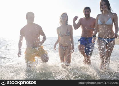 happy people group have fun run and jump on beach beautiful sand beach