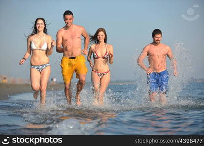 happy people group have fun run and jump on beach beautiful sand beach