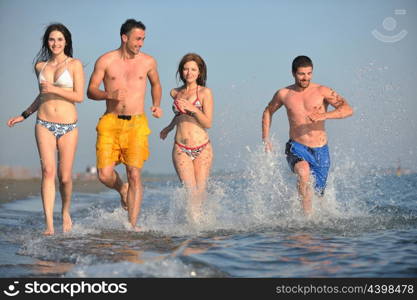 happy people group have fun run and jump on beach beautiful sand beach