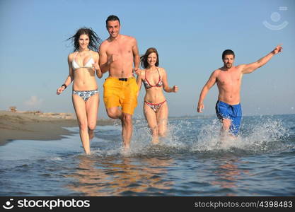 happy people group have fun run and jump on beach beautiful sand beach