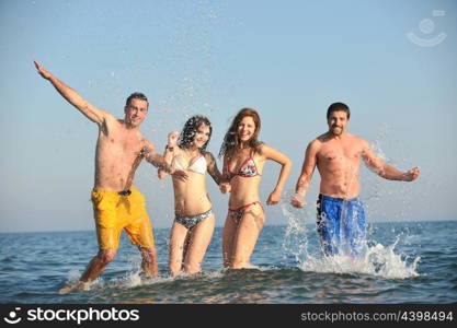 happy people group have fun run and jump on beach beautiful sand beach