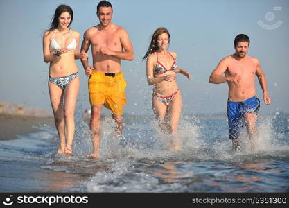 happy people group have fun run and jump on beach beautiful sand beach