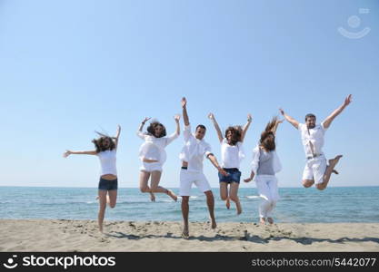 happy people group have fun run and jump on beach beautiful sand beach