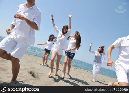 happy people group have fun run and jump on beach beautiful sand beach