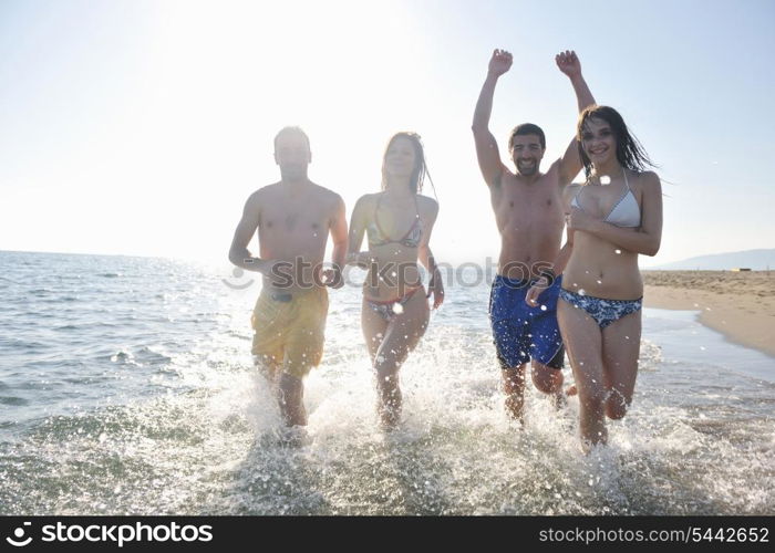 happy people group have fun run and jump on beach beautiful sand beach