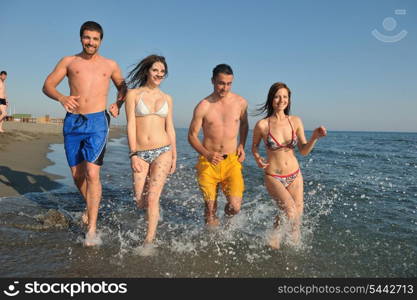 happy people group have fun run and jump on beach beautiful sand beach