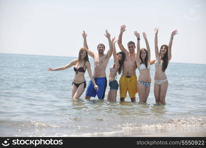 happy people group have fun run and jump on beach beautiful sand beach