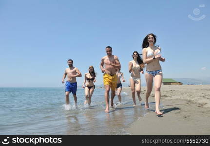 happy people group have fun run and jump on beach beautiful sand beach