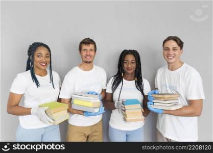 happy people holding bunch books donate them