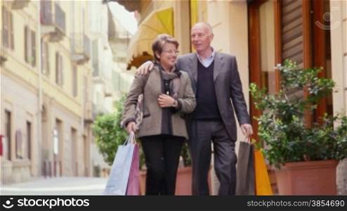 Happy people, leisure, lifestyle, senior, old man and woman shopping. Seniors walking and having fun in city street. 1of7