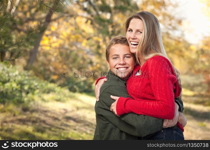 Happy Playful Mother and Son Pose for a Portrait Outdoors.