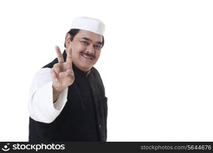 Happy politician gesturing V-sign