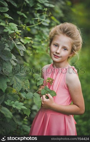Happy portrait of a child in the garden.. A childs portrait set amidst a blossomed garden 6658.
