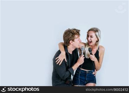 Happy portrait of Couple holding microphone and sing a song