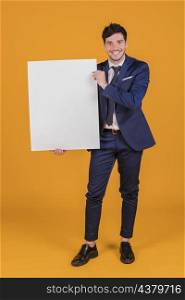 happy portrait young businessman showing white blank placard holding hand