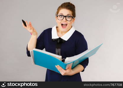 Happy positive accountant business woman holding binder with documents, enjoying her work finding great problem solution.. Happy positive business woman finding solution