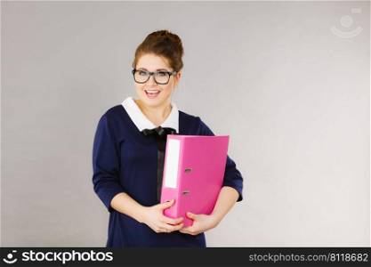 Happy positive accountant business woman holding binder with documents, enjoying her work.. Happy positive business woman holding binder with documents