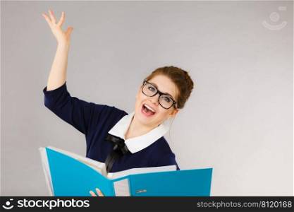 Happy positive accountant business woman holding binder with documents, enjoying her work finding great problem solution.. Happy positive business woman finding solution