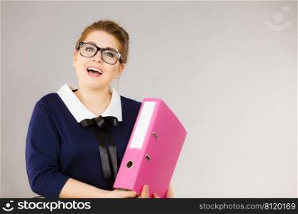 Happy positive accountant business woman holding binder with documents, enjoying her work.. Happy positive business woman holding binder with documents
