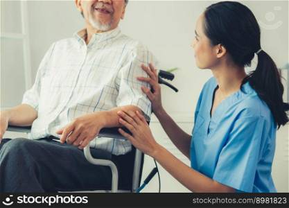 Happy positive asian nurse giving support and touching contented senior man with love. Nursing home for the elderly, elderly health and illness, senior patient carer.. Happy positive asian nurse giving support and touching contented senior man.