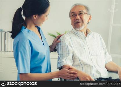 Happy positive asian nurse giving support and touching contented senior man with love. Nursing home for the elderly, elderly health and illness, senior patient carer.. Happy positive asian nurse giving support and touching contented senior man.