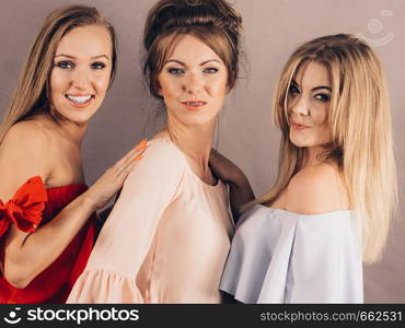 Happy positive female friends having fun enjoying their feminine leisure time. Friendship concept.. Positive female friends having fun