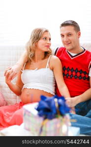 Happy pregnant and husband with gifts for their unborn baby&#xA;