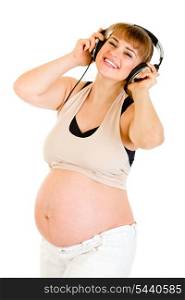 Happy pregnant woman listening music in headphones isolated on white&#xA;