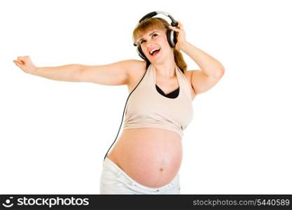 Happy pregnant woman listening music in headphones isolated on white&#xA;