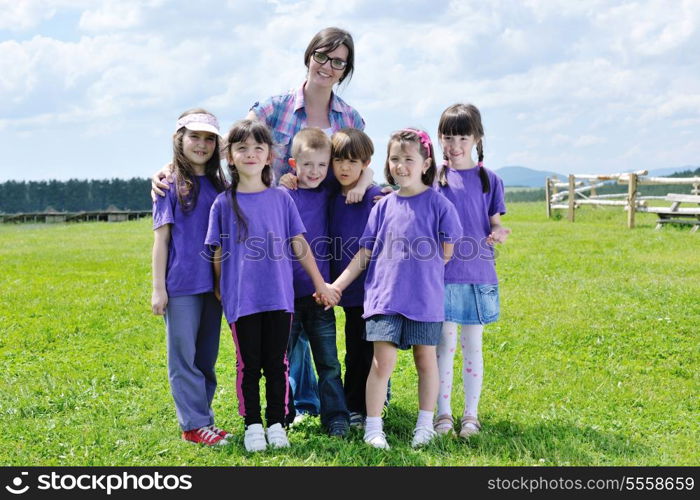 happy preschool kids group have fun and play game on outdoor classes in nature