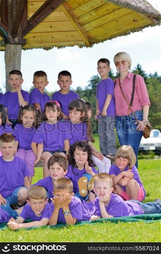 happy preschool kids group have fun and play game on outdoor classes in nature
