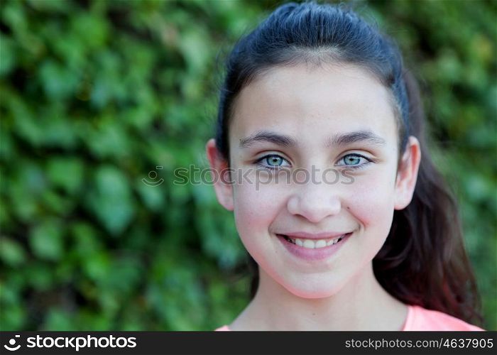 Happy preteen girl with blue eyes smiling at outside