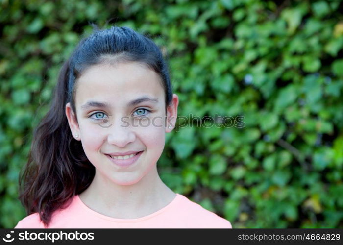 Happy preteen girl with blue eyes smiling at outside