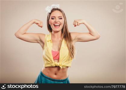 Happy pretty pin up girl showing off muscles.. Happy strong pretty retro pin up girl woman showing off muscles.